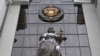 RUSSIA -- A statue of Themis, an ancient Greek Goddess of Justice, and a Russian national state emblem are seen at the entrance of Russia's Supreme Court in Moscow on November 30, 2023